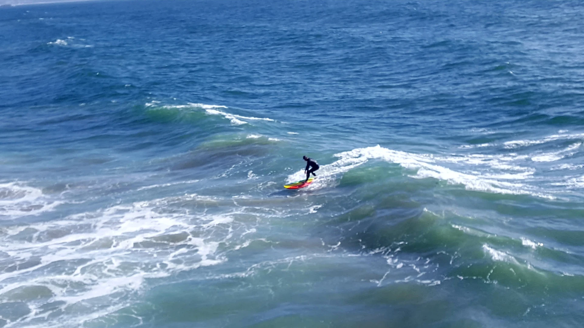 A person skillfully riding a surfboard on ocean waves, showcasing balance and agility.